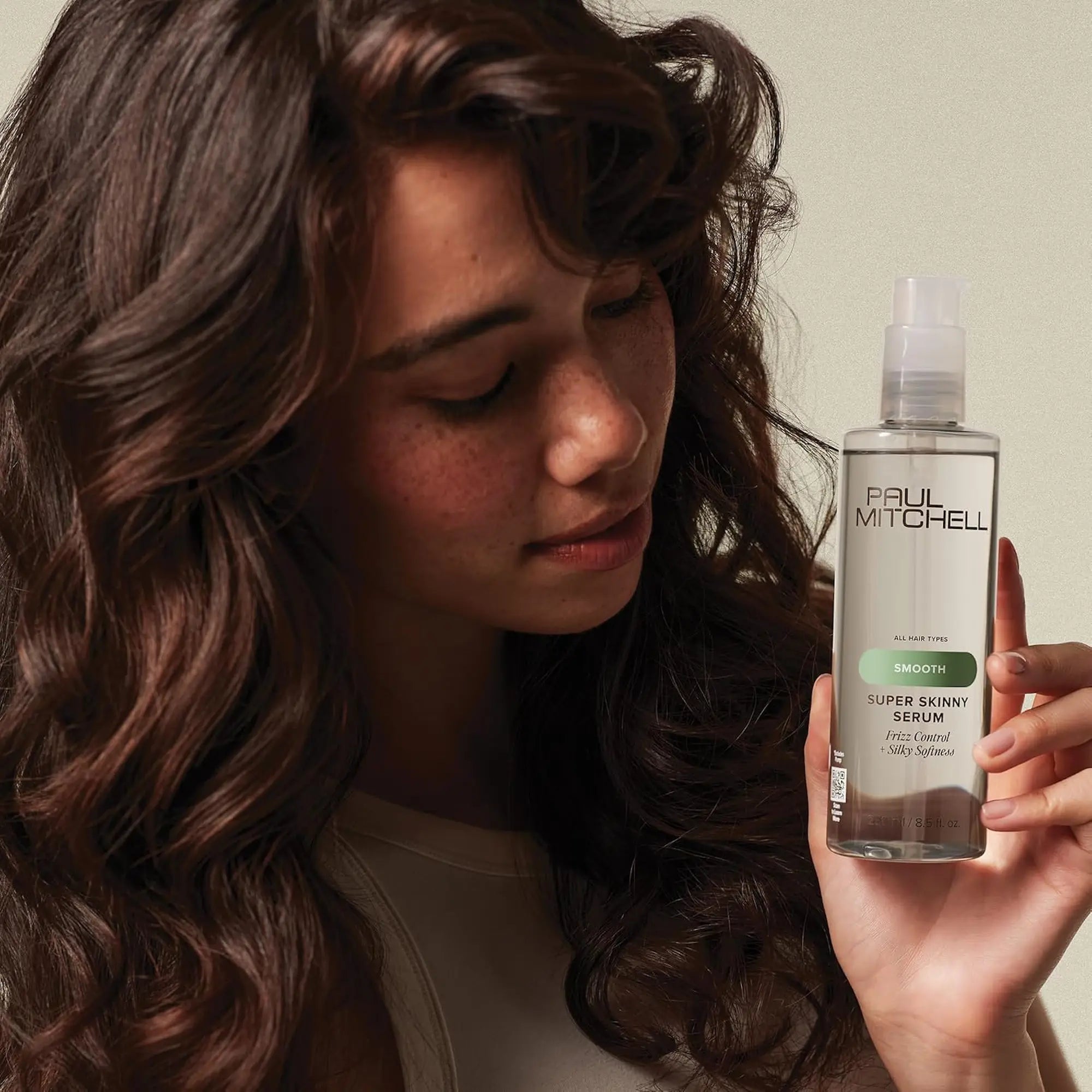 Bouteille transparente de sérum Paul Mitchell Super Skinny : contrôle des frisottis et douceur soyeuse, avec bouchon pompe blanc.