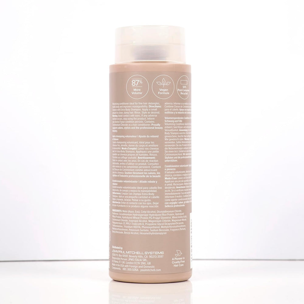 Bouteille beige de revitalisant Paul Mitchell Extra-Body  300ml : étiquette mauve, pour ajouter du rebond et de la plénitude aux cheveux fins ou normaux.