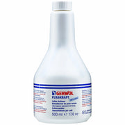 Flacon de solution liquide transparente pour ramollisseur de peau cornée, avec un bouchon applicateur, posé à côté d'une râpe plantaire.