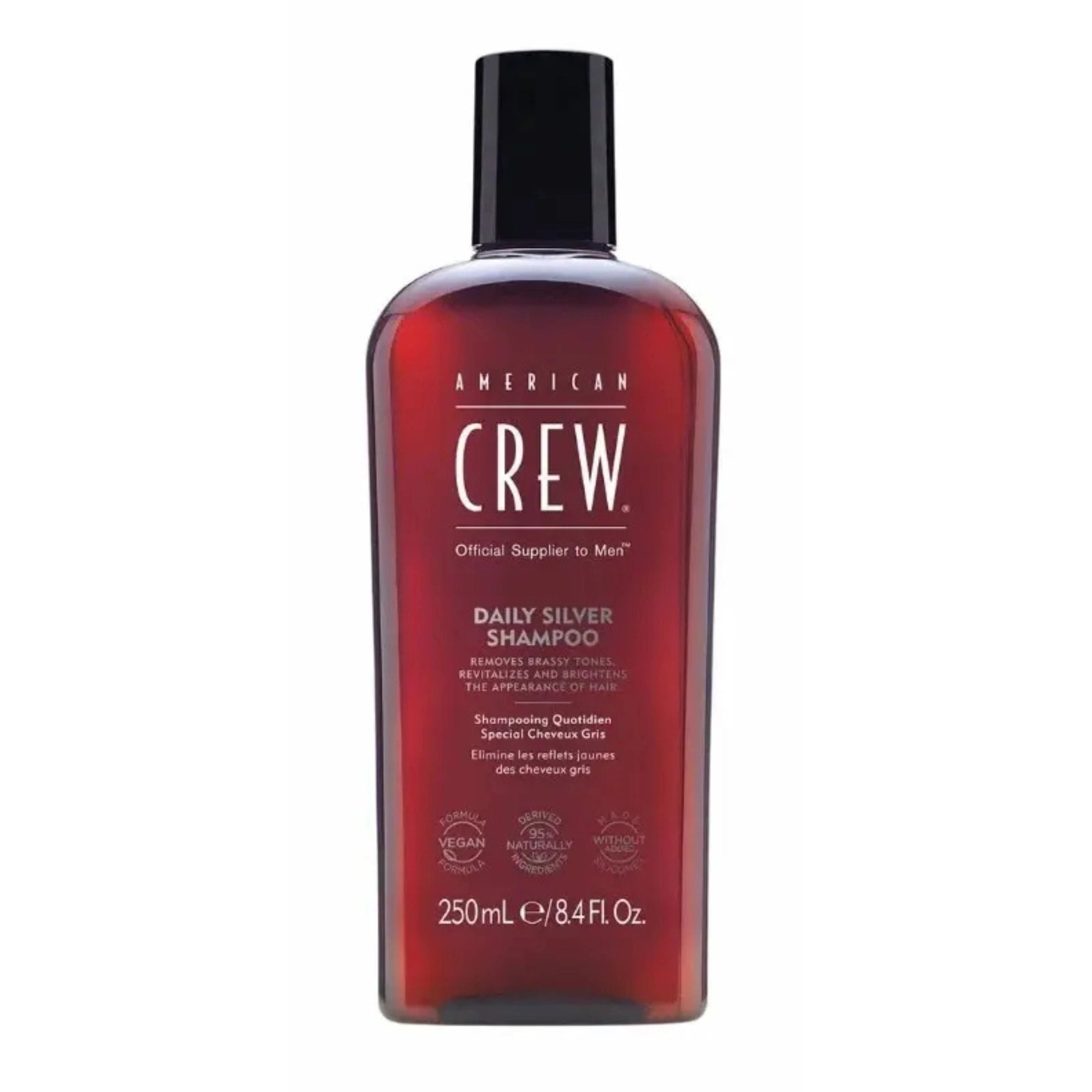 Flacon gris de shampoing American Crew Daily Silver avec bouchon noir, conçu pour neutraliser les reflets jaunes des cheveux gris.