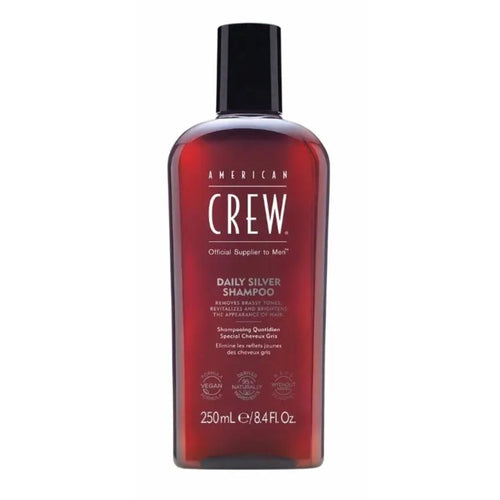 Flacon gris de shampoing American Crew Daily Silver avec bouchon noir, conçu pour neutraliser les reflets jaunes des cheveux gris.